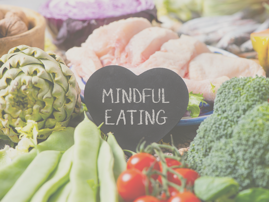 fruit and vegetables on display with a heart shaped chalkboard sign that has the words Mindful Eating written on